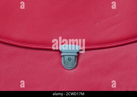 Fashionable red bag from genuine leather close-up, texture.Detail of leather briefcase, metal clasp Stock Photo