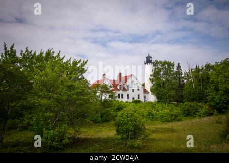 Point Iroquois Lighthouse. The Point Iroquois Lighthouse is located on the coast of Lake Superior in the Hiawatha National Forest of Michigan. Stock Photo
