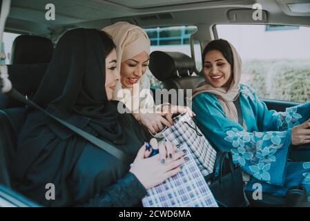 Three women friends going out in Dubai. Girls wearing the united arab emirates traditional abaya Stock Photo