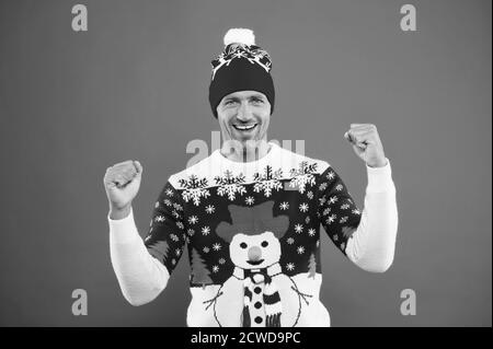 Winter chill get strong. Unshaven guy smile in snowman winter style jumper. Happy man with casual winter look. Warm knitted design for cold weather. Keeping warm and festive during winter holidays. Stock Photo