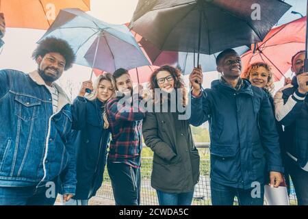 Friends making the best of rain and bad weather Stock Photo