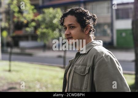Beautiful portrait of a young man walking down the street Stock Photo