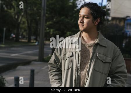 Beautiful portrait of a young man walking down the street Stock Photo