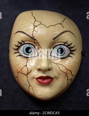 Cracked Doll Face Mask Isolated Against Black Background Stock Photo