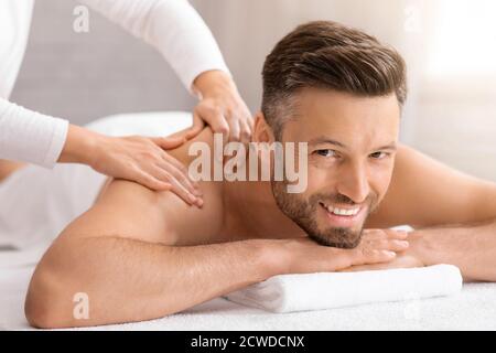 Happy middle aged man attending spa salon Stock Photo