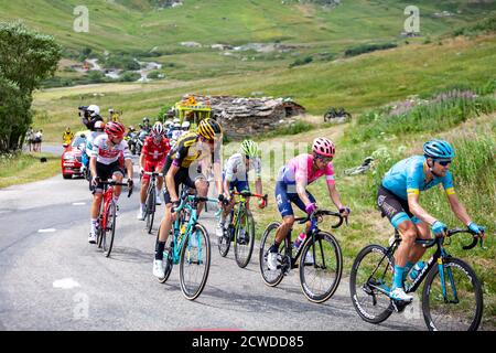 Col de Iseran, France - July 26, 2019: The Peloton climbing the road to Col de Iseran during the stage 19 of Le Tour de France 2019. Stock Photo