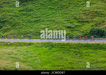 Col de Iseran, France - July 26, 2019: The Peloton climbing the road to Col de Iseran during the stage 19 of Le Tour de France 2019. Stock Photo