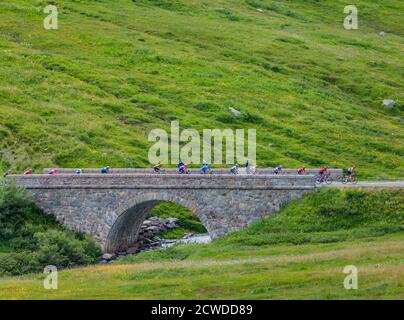 Col de Iseran, France - July 26, 2019: The Peloton climbing the road to Col de Iseran during the stage 19 of Le Tour de France 2019. Stock Photo