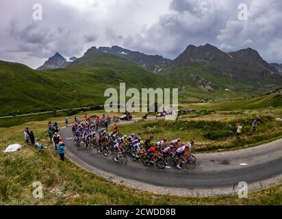 Col de Iseran, France - July 26, 2019: The Peloton climbing the road to Col de Iseran during the stage 19 of Le Tour de France 2019. Stock Photo