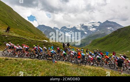 Col de Iseran, France - July 26, 2019: The Peloton climbing the road to Col de Iseran during the stage 19 of Le Tour de France 2019. Stock Photo