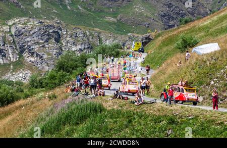 Col de Iseran, France - July 26, 2019: The Cohonou Caravan during the passing of the Publicity Caravan, before the cyclists,on  the road to Col de Ise Stock Photo