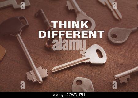 Diverse keys over wooden background and think different text Stock Photo