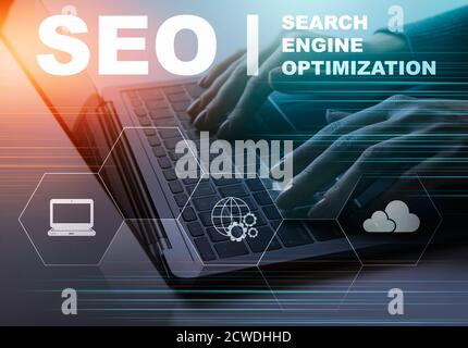 Seo Specialist Working On Laptop Sitting In Modern Office Stock Photo