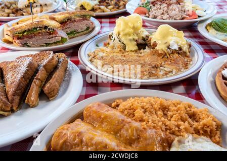 Generous servings of a variety of Latino themed breakfast choices full of delicious flavors on checkered table. Stock Photo