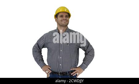Smiling construction worker in yellow helmet looking at perfect well built object Hands on hips on white background. Stock Photo