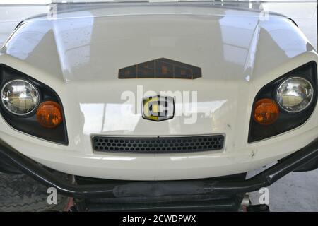 Small bus front view. Automobile parts in the workshop and service station. Muscat, Oman Stock Photo