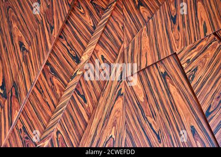 3D wood wall panels. Wood veneer wall panels elements are covered with dust. Rosewood reconstituted veneer. Furniture manufacturing. Closeup Stock Photo