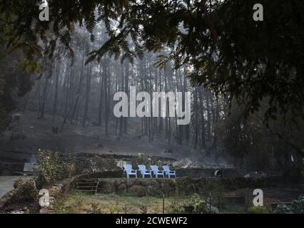Angwin, United States. 29th Sep, 2020. Four blue plastic chairs and a patch of grass sit in front of a burned residence in Angwin, California on Tuesday, September 29, 2020. The Glass Fire has burned over 40,000 acres and is only 2% contained. Photo by Terry Schmitt/UPI Credit: UPI/Alamy Live News Stock Photo