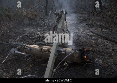 Angwin, United States. 29th Sep, 2020. A burning high volltage power pole lies beside the road in Angwin, California on Tuesday, September 29, 2020. The Glass Fire has burned over 40,000 acres and is only 2% contained. Photo by Terry Schmitt/UPI Credit: UPI/Alamy Live News Stock Photo