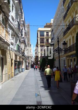 The narrow streets of Cadiz, lined by four-storey high buildings with windowed balconies, provide plenty of shade in Cadiz September 21, 2012. Its colonial streets appear unchanged from centuries past and are so narrow there's little room for cars, and most people get around on foot. Not as famous perhaps as other cities in the south of Spain such as Seville, Granada and Cordoba, and not as frequented by foreign tourists, the coastal fortress city of Cadiz is one of the country's most attractive destinations boasting a history of almost legendary proportions. Founded more than 3,000 years ago,