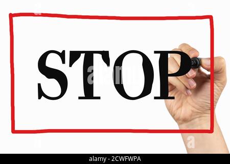 Stop sign with red frame. Doodle  on a whiteboard, written with black and red marker in a hand. Scribble sketch text on a board Stock Photo