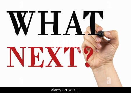 What next. Phrase on a whiteboard, written with black marker in a hand. Stock Photo