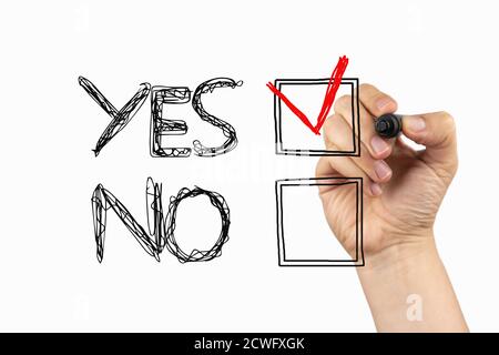 Yes or No choice. Positive decision in checkbox on a whiteboard, written with black and red marker in a hand. Scribble sketch text on a board Stock Photo