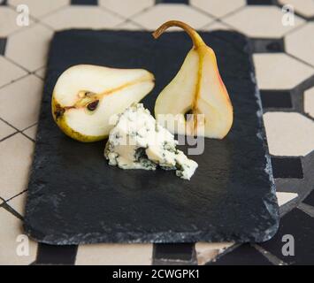 Blue cheese and ripe pears on the black plate Stock Photo