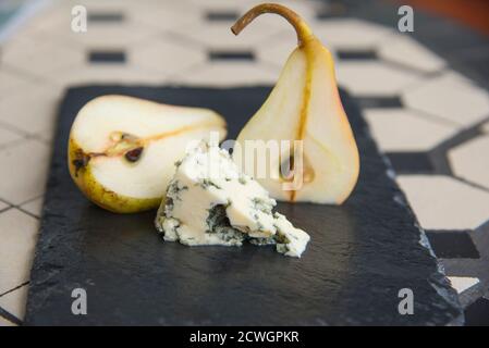 Blue cheese and ripe pears on the black plate Stock Photo