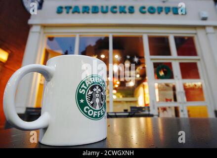 An empty cup is left on a table outside a Starbucks coffee shop in London December 1, 2011. Picture taken December 1, 2011.   To match Special Report BRITAIN-STARBUCKS/TAX   REUTERS/Luke MacGregor/Files    (BRITAIN - Tags: BUSINESS)
