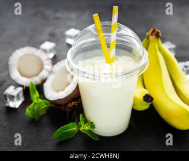 Pina colada alcoholic fresh cocktail served cold with coconut and banana on a black  background Stock Photo