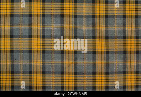 Woolen fabric in black and yellow check. Seamless pattern. Natural background. Vintage-inspired print. Seamless fabric texture. Fashionable print. Stock Photo