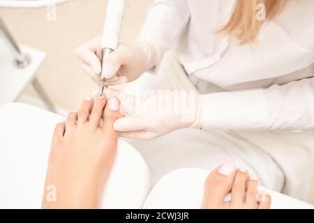 Classic pink wedding toe nail manicure on white backdrop. Spa treatment concept Stock Photo