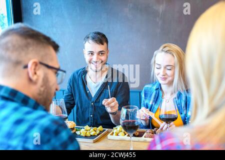 Happy couples having fun while enjoying lunch at fast food restaurant Stock Photo