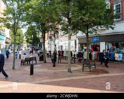 Pedestrianised streets in the centre of Rugby town with people shopping in covid times Stock Photo