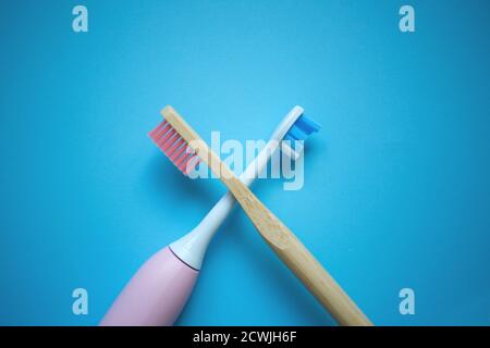 two ultrasonic electric toothbrushes on a blue background Stock Photo