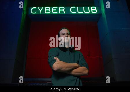 Portrait of professional computer gamer standing with arms crossed and looking at camera Stock Photo