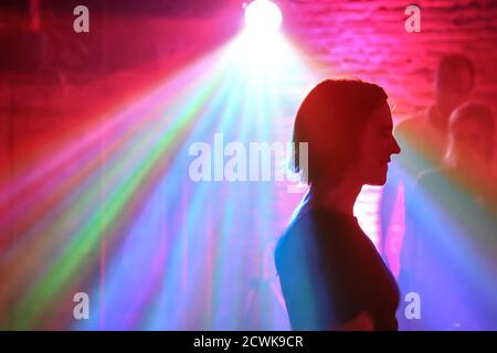 Dancing in spot light in club Stock Photo