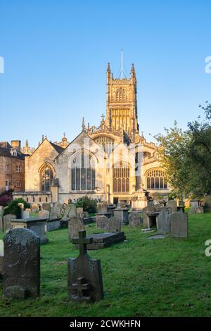 The Church of St. John the Baptist from the garden of rememberance at sunrise in autumn. Cirencester, Cotswolds, Gloucestershire, England Stock Photo