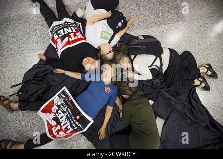 Protesters from the 'The Toronto No Line 9 Network' perform a 'die-in' to demonstrate what they say are the possible effects if the Enbridge operated 'Line 9' petroleum pipeline, which runs under the Finch subway station, ruptured, in Toronto, June 29, 2015.  Enbridge has been seeking permission to reverse the flow of the pipeline that runs from southern Ontario to Montreal. The National Energy Board has ordered Enbridge to conduct hydrostatic testing before they can proceed with the plan, according to local media reports.  REUTERS/Mark Blinch