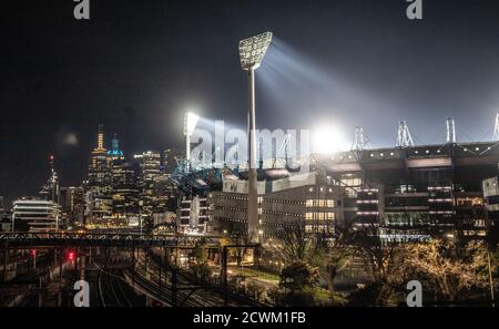 Melbourne Australia : The Melbourne Cricket Ground (MCG) flood lights and city skyline at night.