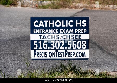 A sign offering a service that prepares students for entrance exams to Catholic high schools. In Whitestone, Queens, New York. Stock Photo