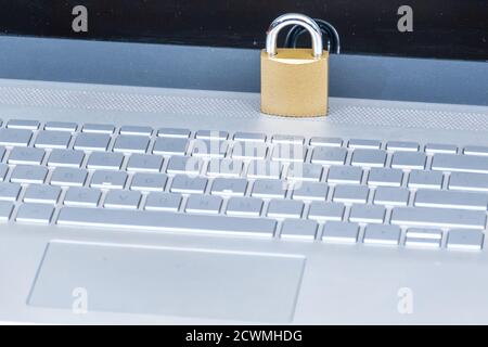 locked padlock placed on a laptop, digital security concept