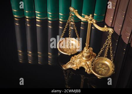 above picture of a golden justice scales in front of law books Stock Photo