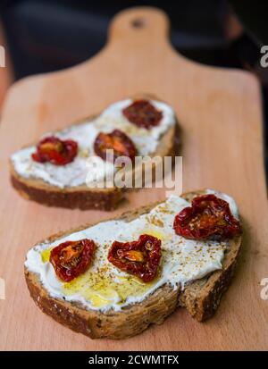 Sandwiches with soft cheese and dried tomatoes Stock Photo
