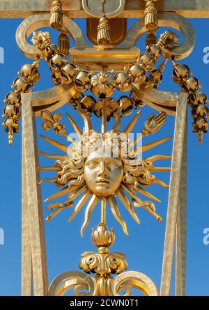Symbol of Louis XIV the Sun King on the golden gate of Versailles Castle Stock Photo