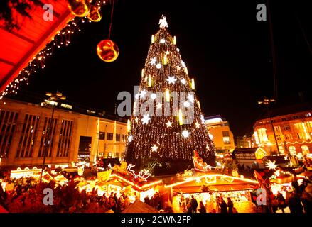 A decorated Christmas tree is lighted up at a Christmas market on its opening day in Dortmund November 21, 2011. The Christmas tree of Dortmund is the largest in the world and is built with a scaffold, covered with 1,700 Norway spruces, 40,000 lights and is 45m (148 ft) high.  REUTERS/Ina Fassbender (GERMANY - Tags: SOCIETY ANNIVERSARY)