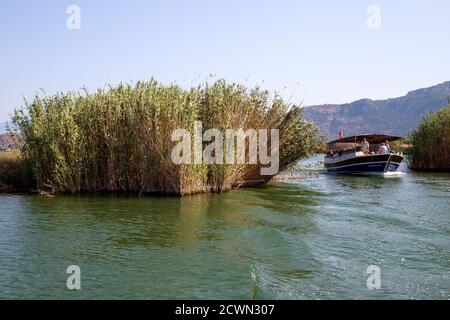 Dalyan, Mugla / Turkey - 09/26/2020: Scenic views of the Lycian rock tombs, and boat trips with tourists on the Dalyan River in Turkey. Stock Photo