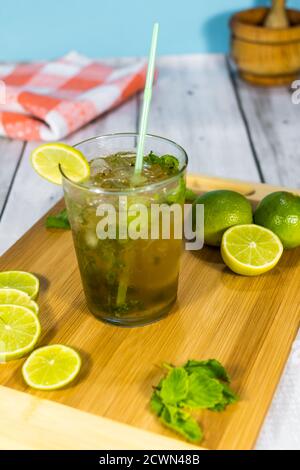 Cuban mojito made with rum, lime, brown sugar and soda on a wooden board. typical Cuban drink Stock Photo