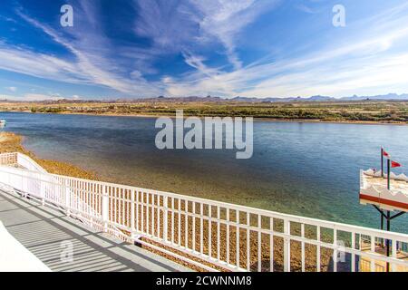 Riverwalk In Laughlin Nevada. Streetlights and palm trees line the empty  riverwalk along the Colorado River in downtown Laughlin Nevada. Stock Photo